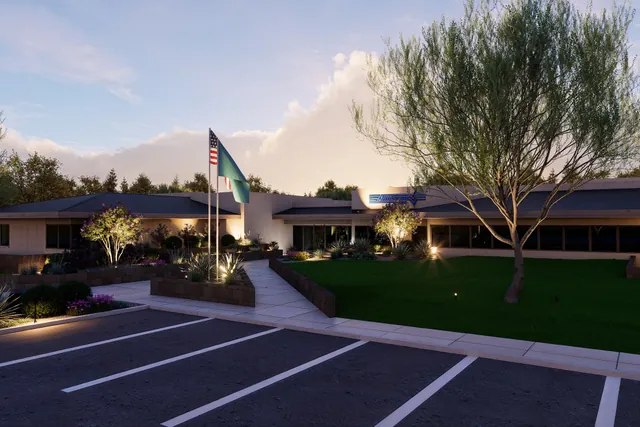 Dusk rendering of the campus with the flags and parking field lit